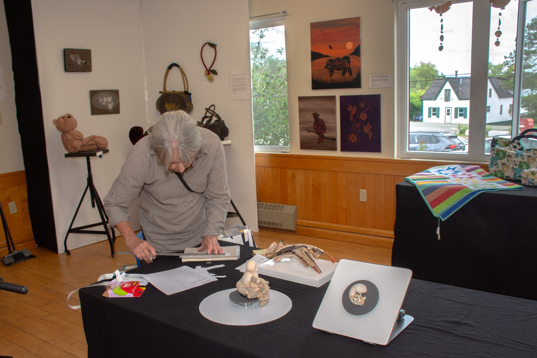 Denise Dumas working on her art display